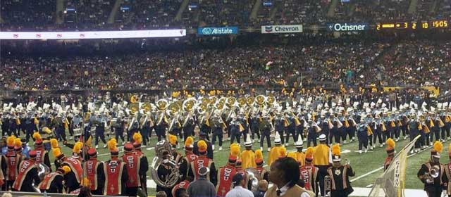 The Grambling State University Band wait on the sidelines to take the field as Southern University's Band performs in formation during the 2013 halftime show.
