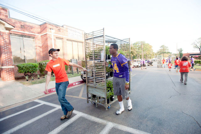 Retool Your School 2014: Home Depot employee assists an HBCU student with moving plants for campus improvements.