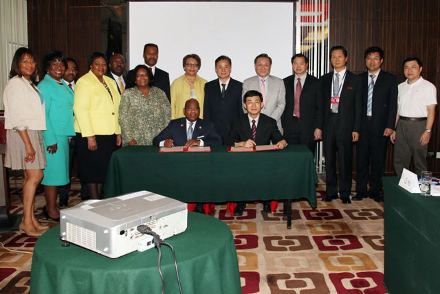MOU signing between 8 HBCUs and the China Education Association for International Exchange (CEAIE) in Beijing, China on July 9, 2014. Dr. David Wilson (seated on left) signed the MOU on behalf of the delegation of senior administrators from Bowie State University, Hampton University, Howard University, Morehouse College, Morgan State University, Spelman College, Tougaloo College and Xavier University of Louisiana.
