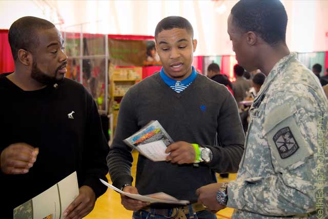 Black College Expo 2014: College fair attendee talks with military recruiter at about college options after high school.