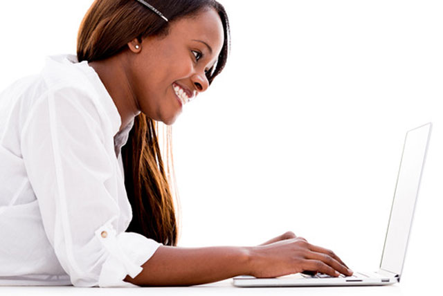 African-American Female student using a laptop to fill out FAFSA Application online.
