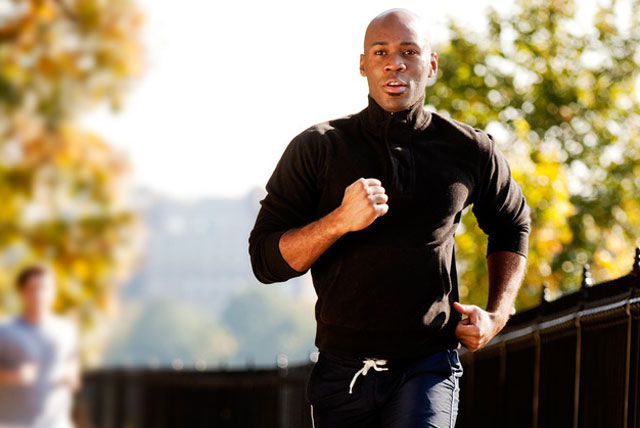 A black male HBCU student running on campus following healthy living tips.