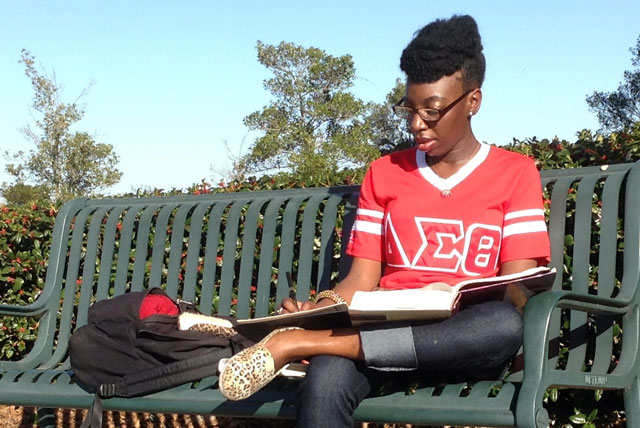 Delta Sigma Theta member T'Edra Jackson studies outside on the campus of Paul Quinn College.