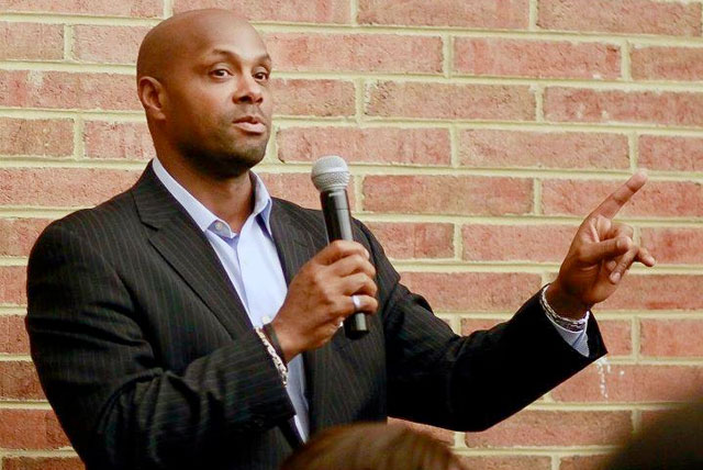 Chris Cathcart pictured holding a microphone speaking in front of an audience on fundraising party ideas for HBCU groups.