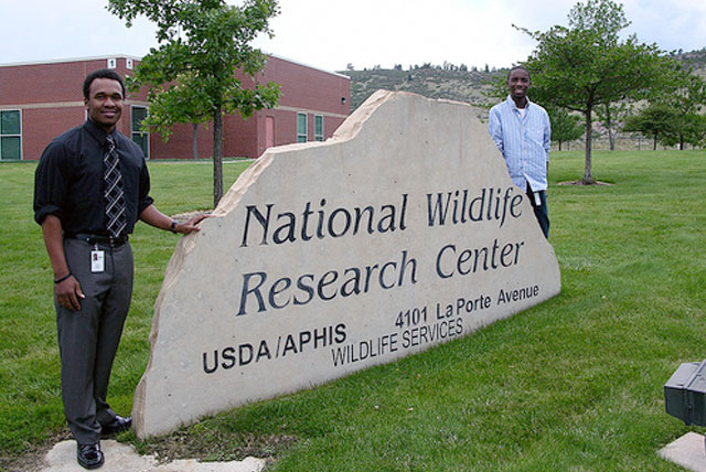 Thurgood Marshall College Fund interns Joseph Williams (left) and Aaron Thomas stand in front of the National Wildlife Research Center Sign during their Government Internships during the summer of 2012.