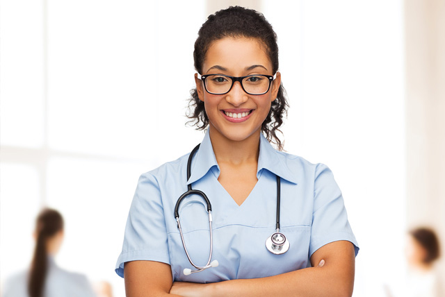 Tylenol Scholarship: Smiling female african American doctor or nurse in eyeglasses with stethoscope.