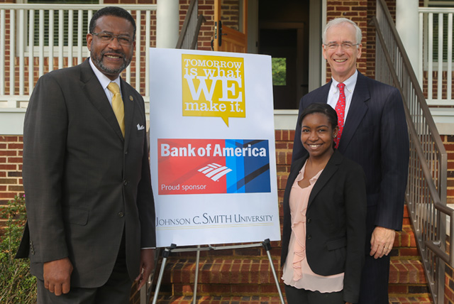 Dr. Ronald L. Carter, president of Johnson C. Smith University poses with a Bank of America grant representatives in front of the Dr. George E. Davis House.