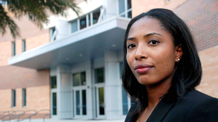 Law student Herrittaccei Shabazz stands in front of the FAMU College of Law building in Orlando, Florida.