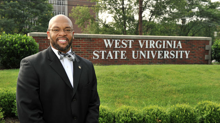 West Virginia State University President Brian O. Hemphill poses in from of the University’s welcome sign.