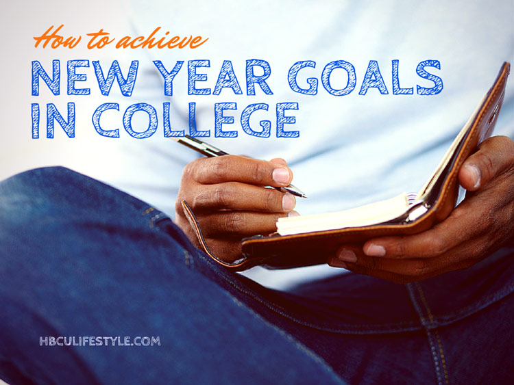 Hands of a young African American male student writing his New Year goals in a notepad.
