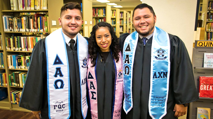 Happy Paul Quinn College class of 2015 Hispanic students pose before commencement ceremony.