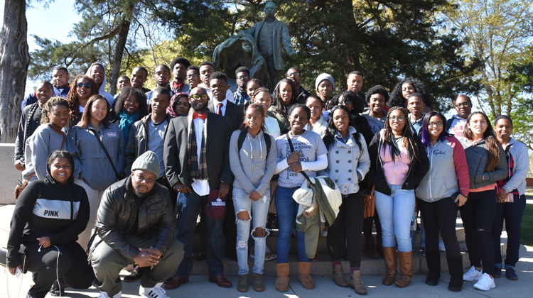 HBCU College Tours: Students on the 2015 Educational Student Tours pose in front of famous Booker T. Washington's Lifting the Veil of Ignorance monument on the campus of Tuskegee University.