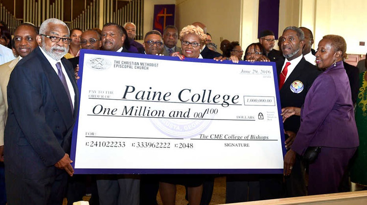The Christian Methodist Episcopal (CME) Church clergy presents an over-sized check that drew a deafening round of applause from Paine faculty, staff, students, alumni, trustees, and friends.