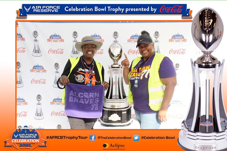 Alcorn State University fans pose with the Celebration Bowl Trophy during the AFRCB trophy tour at the 2016 MEAC/SWAC Challenge.