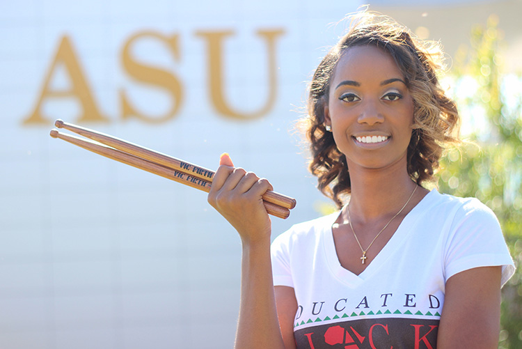 Percussionist Jazz Kelley poses holding her drumsticks at Albany State University.