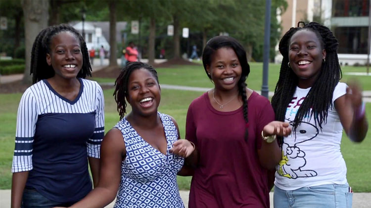 Four smiling prospective HBCU students visit the campus of Claflin University during an open house.