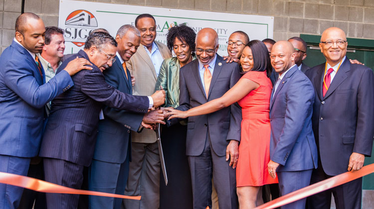 Owners of the Black Television News Channel and Florida Agricultural and Mechanical University administrators participate in a ribbon-cutting from the headquarters of the future channel.